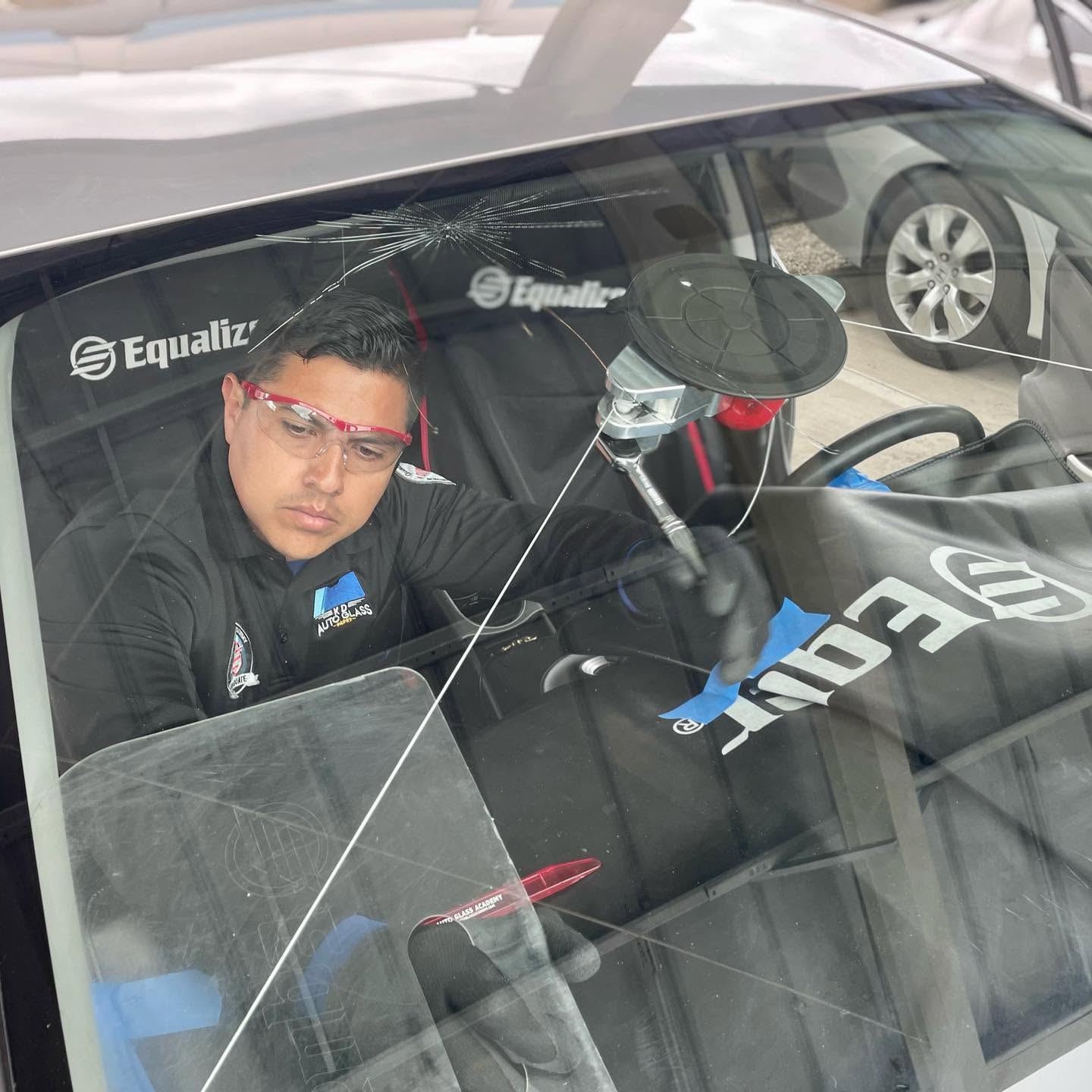 Technician installing windshield on-site
